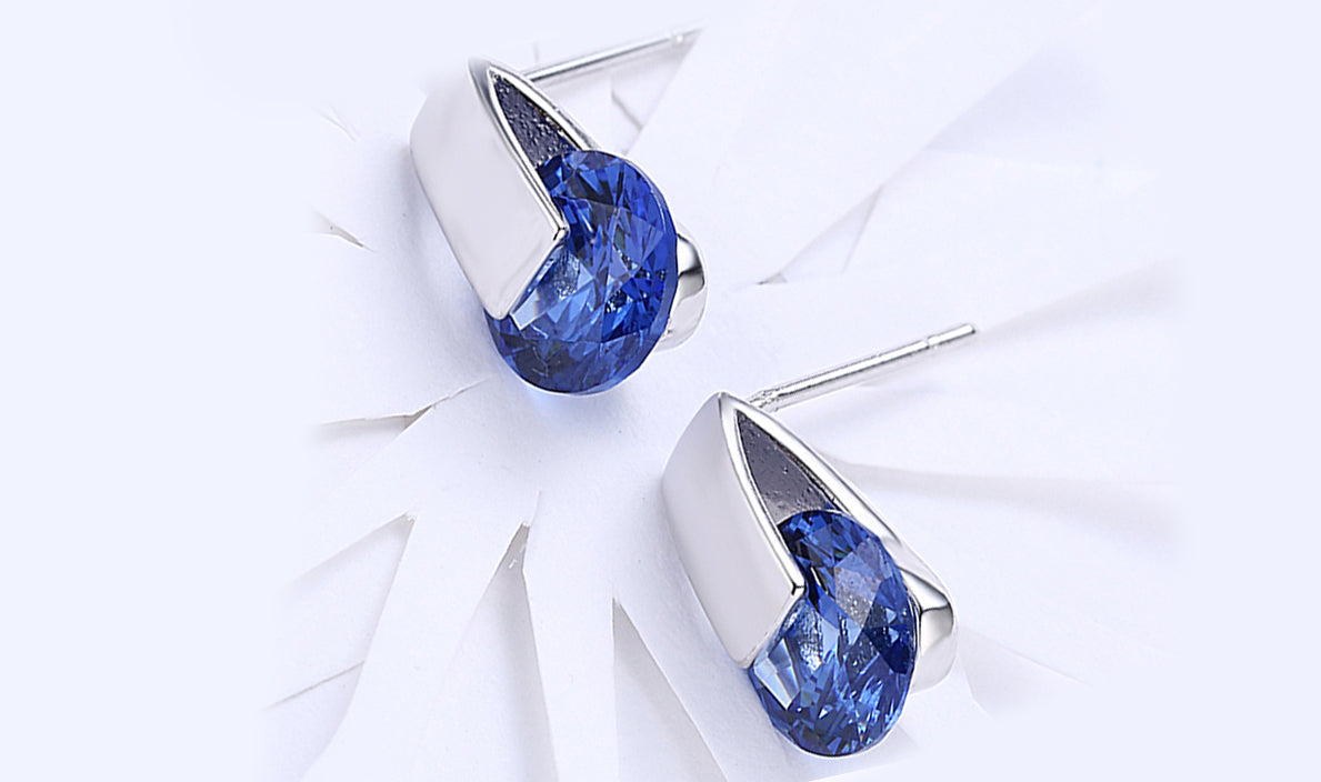 Elegant 14K white gold plated earrings featuring a stunning blue sapphire stone, perfect for any occasion.