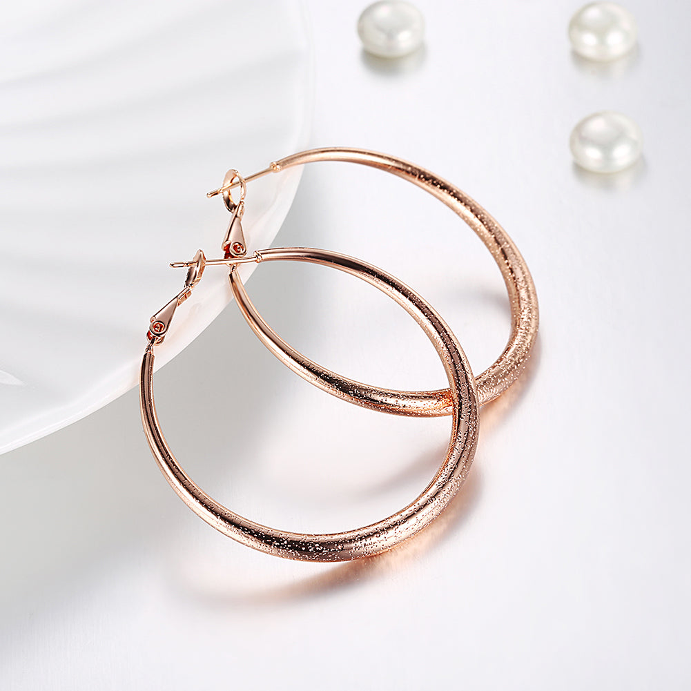 Elegant 1.6-inch round hoop earrings in 18K rose gold plating, showcasing a luxurious and timeless design.