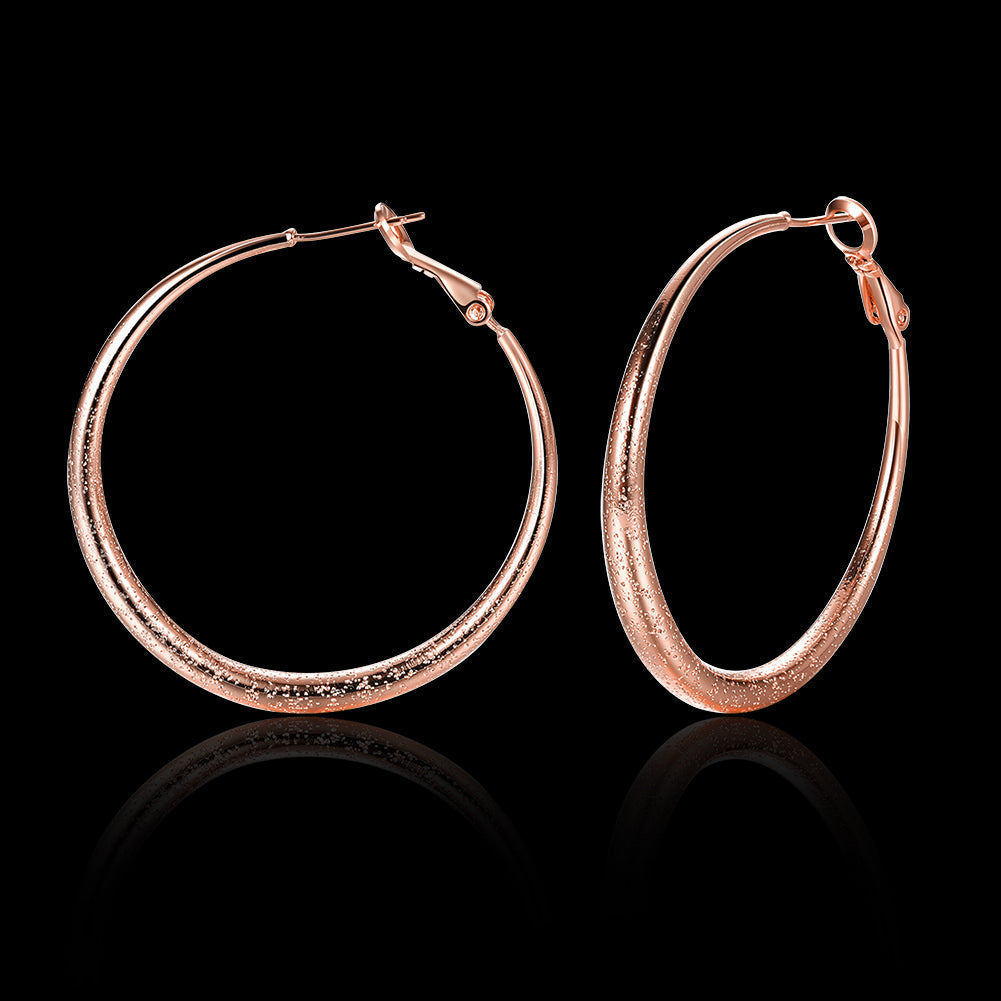 Elegant 1.6-inch round hoop earrings in 18K rose gold plating, showcasing a luxurious and timeless design.