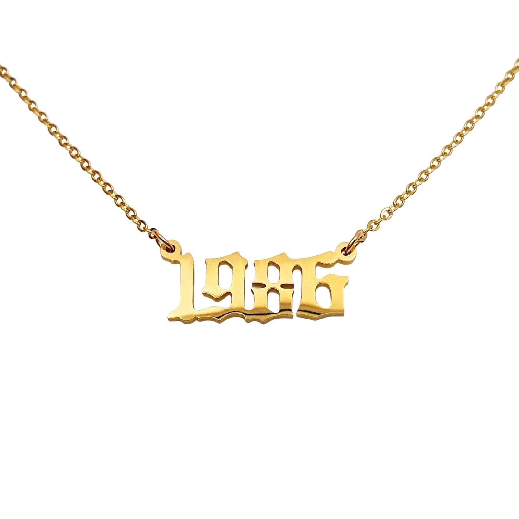 A stylish 1986 Year Necklace made of tarnish-free stainless steel, available in gold and silver finishes, showcasing a bold 2cm pendant on an 18-inch chain.