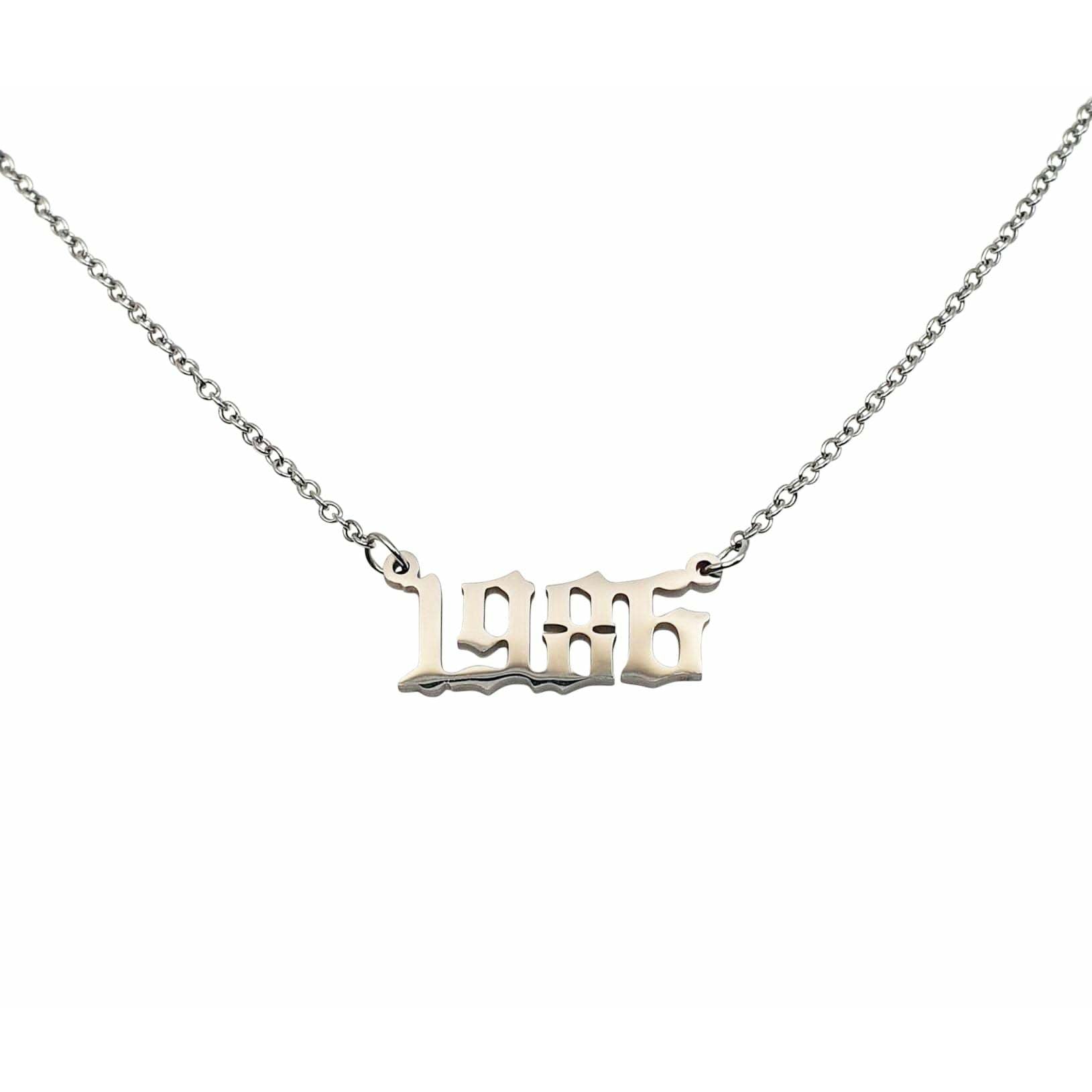 A stylish 1986 Year Necklace made of tarnish-free stainless steel, available in gold and silver finishes, showcasing a bold 2cm pendant on an 18-inch chain.