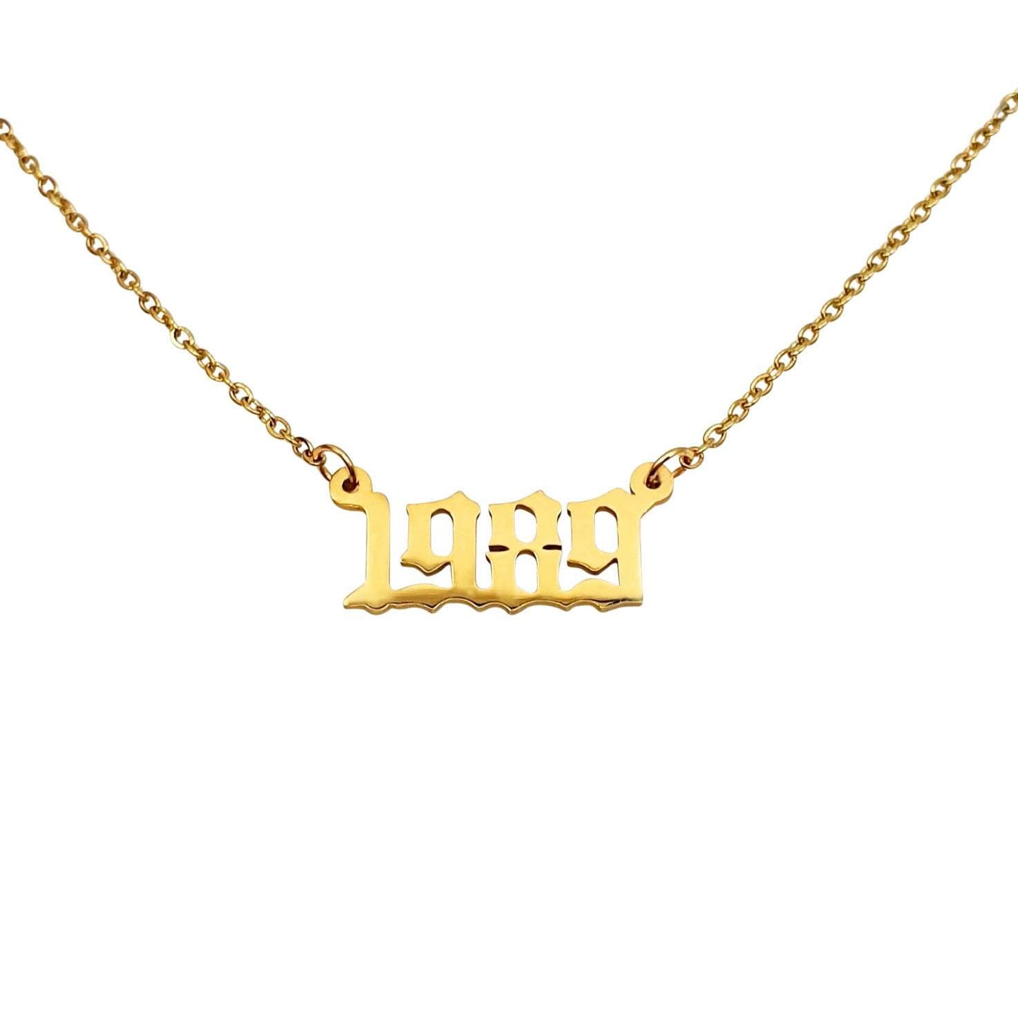 A stylish 1989 Year Necklace made of tarnish-free stainless steel, available in gold and silver finishes, featuring a 2cm pendant on an 18-inch chain.