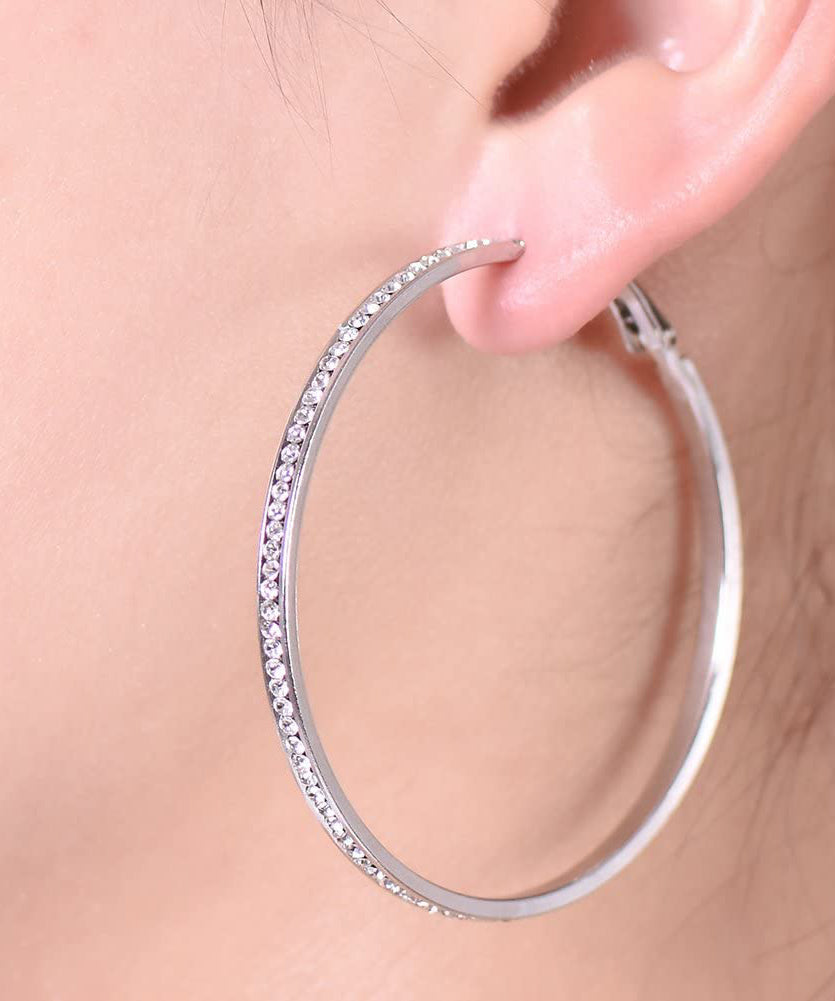 Elegant 2-inch pave hoop earrings featuring sparkling ® Crystals and 18K white gold plating, showcasing Italian craftsmanship.