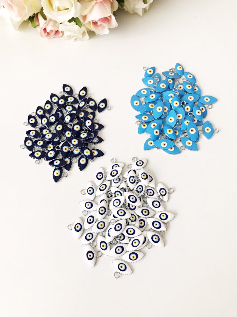 A bulk set of 20 blue evil eye beads, featuring intricate designs and a shiny finish, ideal for jewelry making and DIY projects.