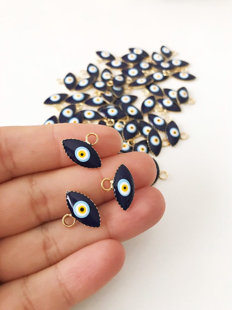 A bulk set of 20 blue evil eye beads, featuring intricate designs and a shiny finish, ideal for jewelry making and DIY projects.