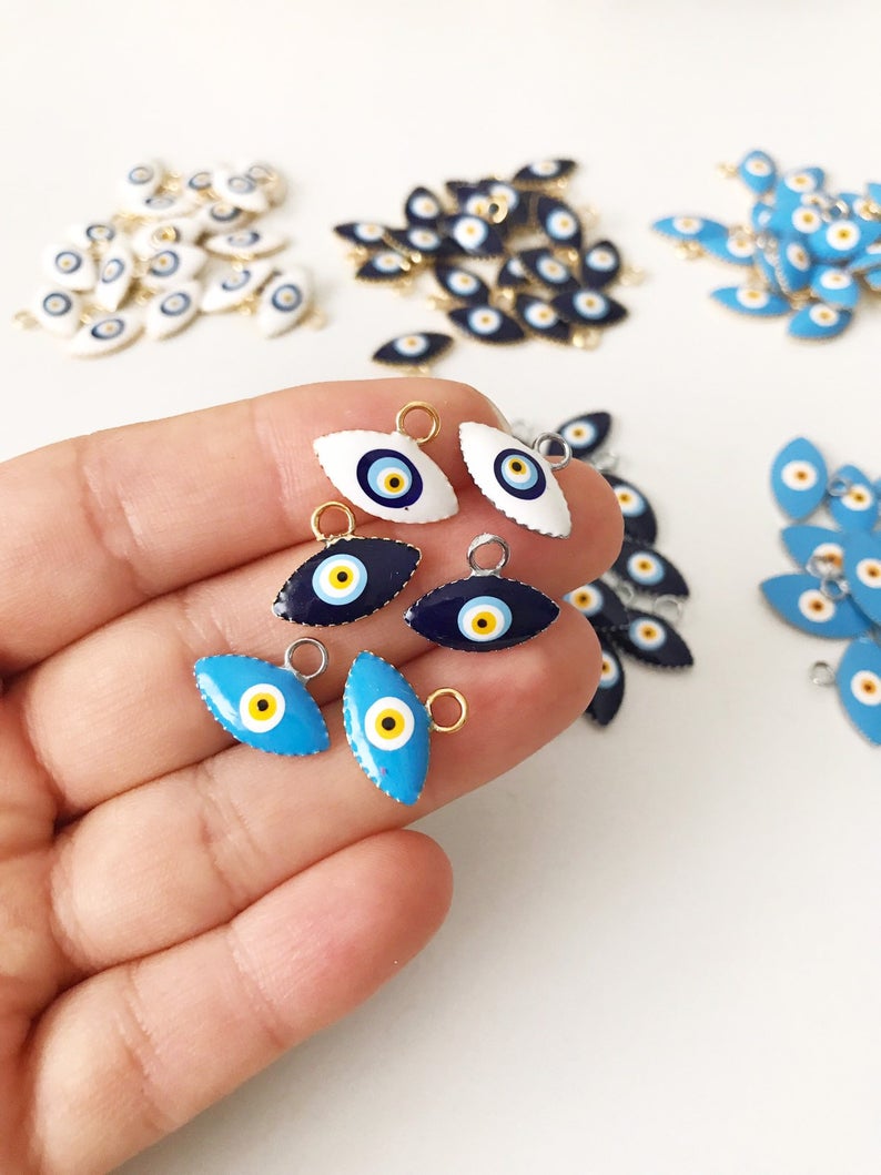 A bulk set of 20 blue evil eye beads, featuring intricate designs and a shiny finish, ideal for jewelry making and DIY projects.