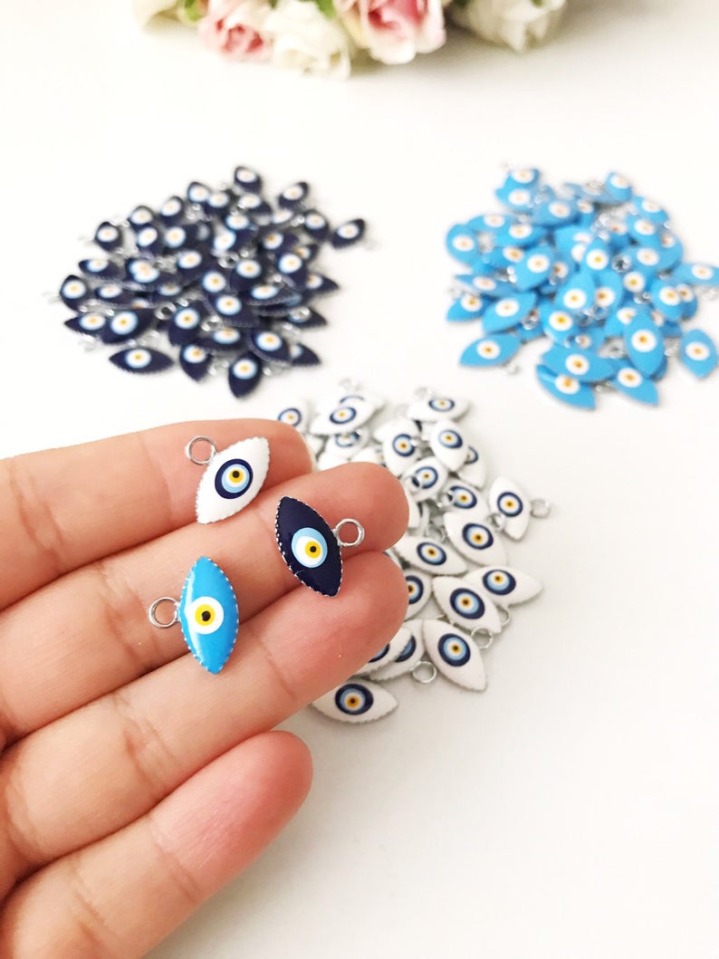 A bulk set of 20 blue evil eye beads, featuring intricate designs and a shiny finish, ideal for jewelry making and DIY projects.