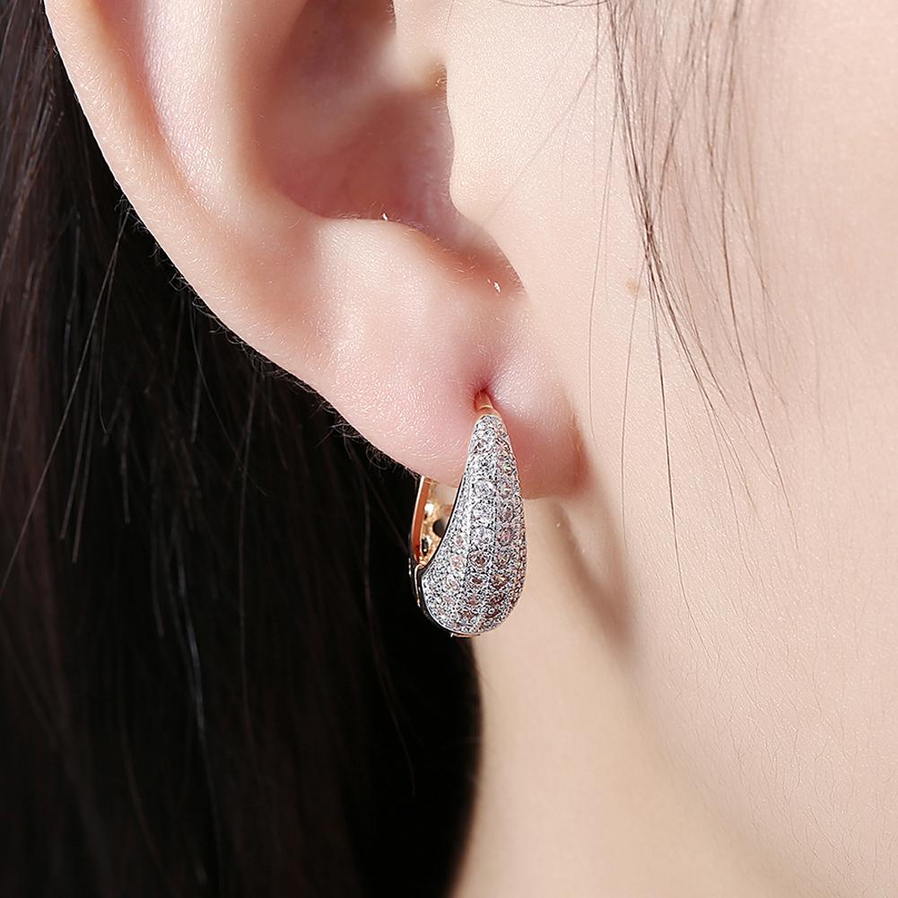 Elegant 26 Stone Teardrop Pave Huggie Earrings in 18K White Gold Plated, featuring a sparkling design and comfortable fit.