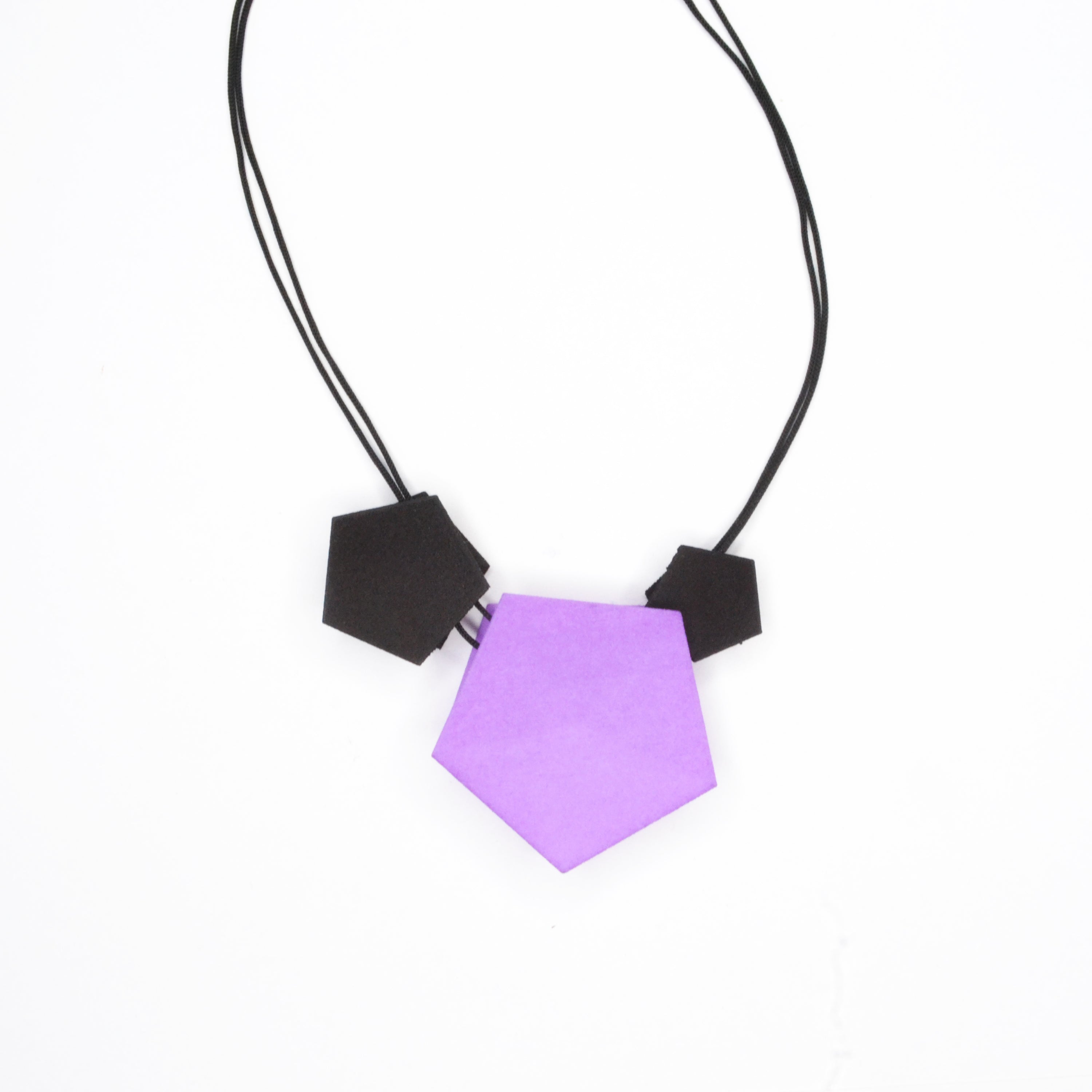 Vertigo 3 Element Necklace featuring three geometric pentagons on a black nylon cord, showcasing vibrant colors and a sterling silver bead for length adjustment.