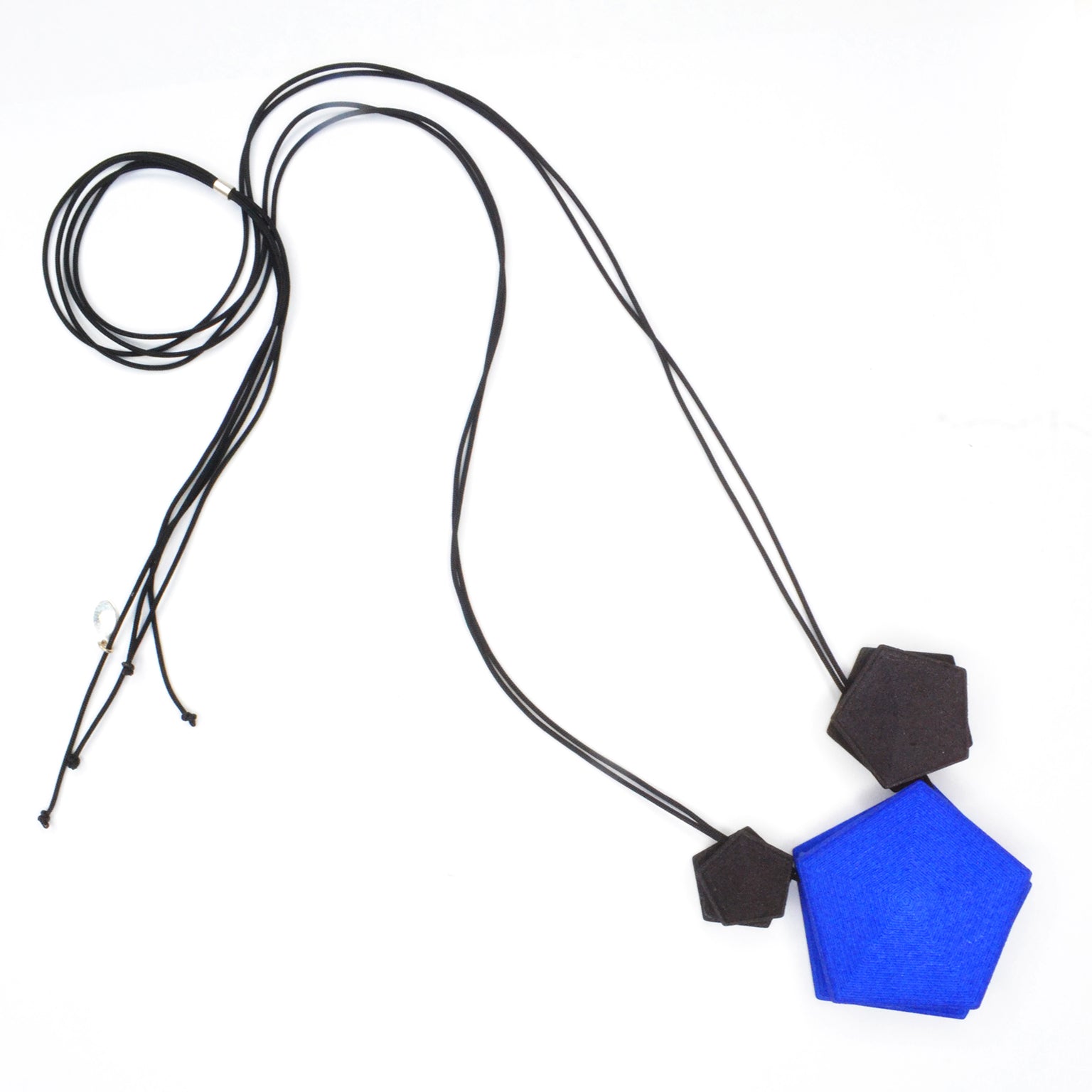 Vertigo 3 Element Necklace featuring three geometric pentagons on a black nylon cord, showcasing vibrant colors and a sterling silver bead for length adjustment.