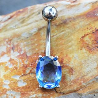 A stunning 316L stainless steel navel ring featuring a blue synthetic tourmaline, elegantly prong set with four prongs.