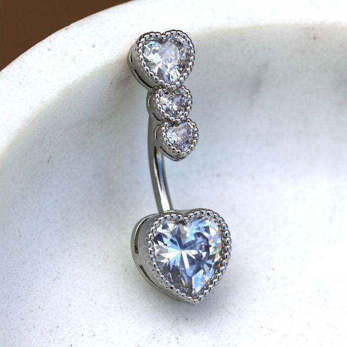 A stunning 316L stainless steel navel ring featuring cascading heart-shaped cubic zirconia stones in various sizes.