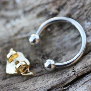 A gold plated heart snap-in captive bead ring made of 316L stainless steel, featuring a winged heart design and tiny clear cubic zirconia stones.