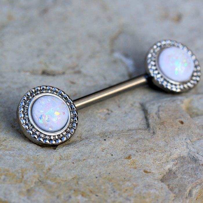 A stunning 316L stainless steel nipple bar featuring an ornate circular design with a round white synthetic opal centerpiece, showcasing elegance and durability.