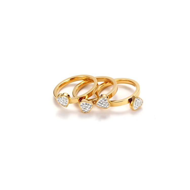 A set of three gold clover rings with cubic zirconia, showcasing a stylish and elegant design.