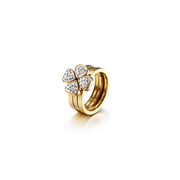 A set of three gold clover rings with cubic zirconia, showcasing a stylish and elegant design.