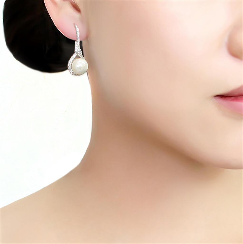 Elegant 3W1478 Rhodium Brass Earrings featuring a white synthetic pearl, showcasing a stylish design.