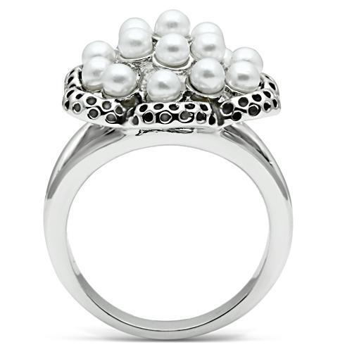 Rhodium brass ring featuring a synthetic white pearl centerpiece, elegantly designed for any occasion.