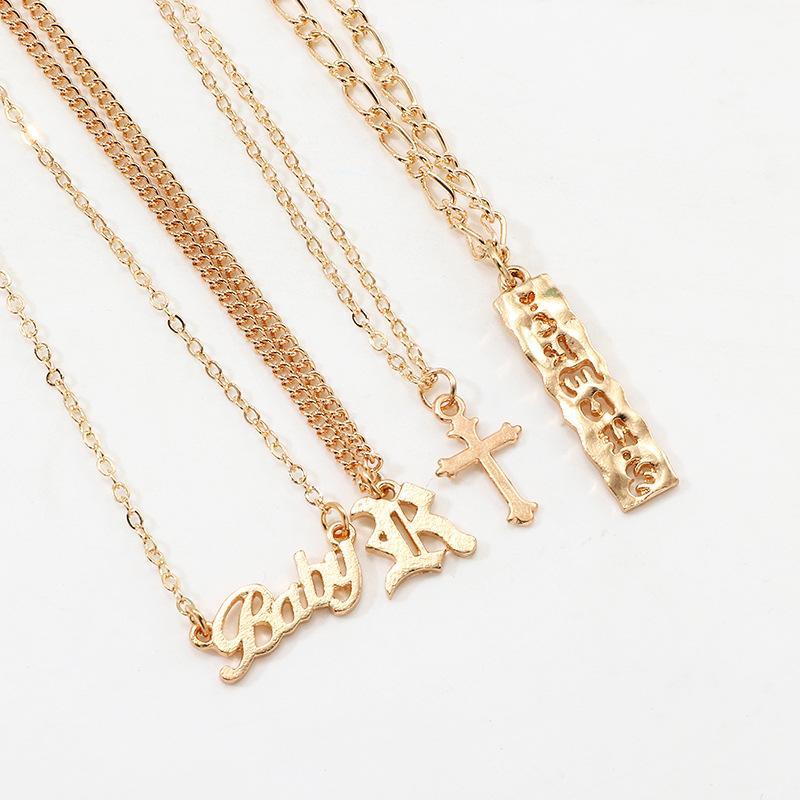 A beautiful 4 Piece Baby Cross Necklace featuring an 18K gold plated finish, designed for children with a lobster clasp and link chain.