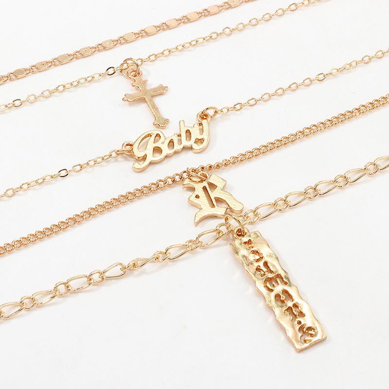 A beautiful 4 Piece Baby Cross Necklace featuring an 18K gold plated finish, designed for children with a lobster clasp and link chain.