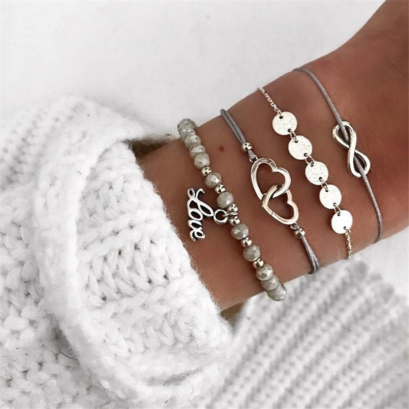 A stunning 4 Piece Infinity Love Bracelet Set featuring 18K white gold plating, showcasing elegant infinity designs.