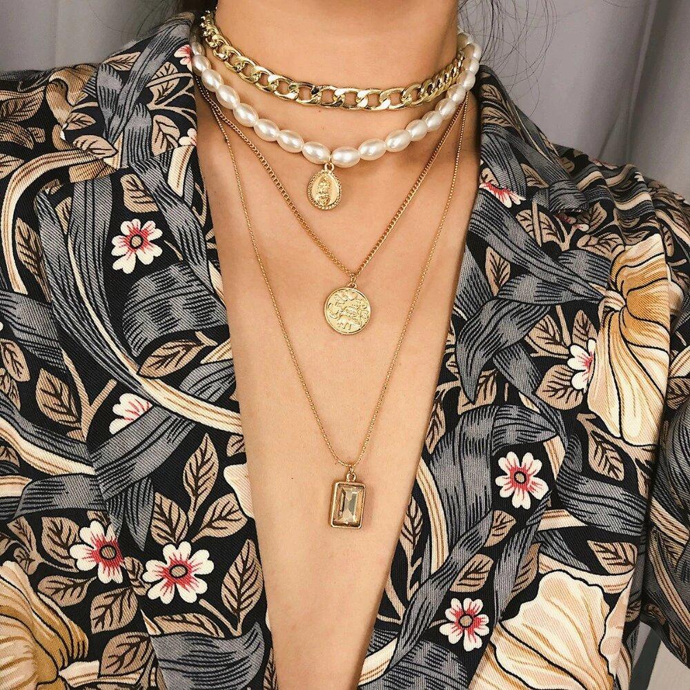 4 Piece Necklace Set featuring a choker, pearl, coin, and pendant, elegantly designed in Italy with 18K gold plating and Austrian crystals.