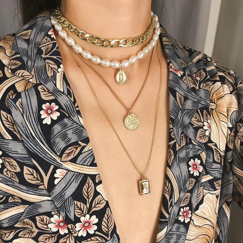 4 Piece Necklace Set featuring a choker, pearl, coin, and pendant, elegantly designed in Italy with 18K gold plating and Austrian crystals.