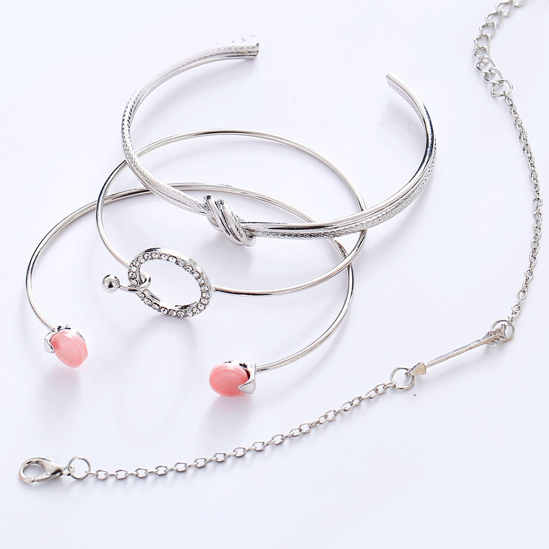 A beautiful 4 piece pink bracelet set featuring crystals, elegantly designed with 18K white gold plating, showcasing Italian craftsmanship.