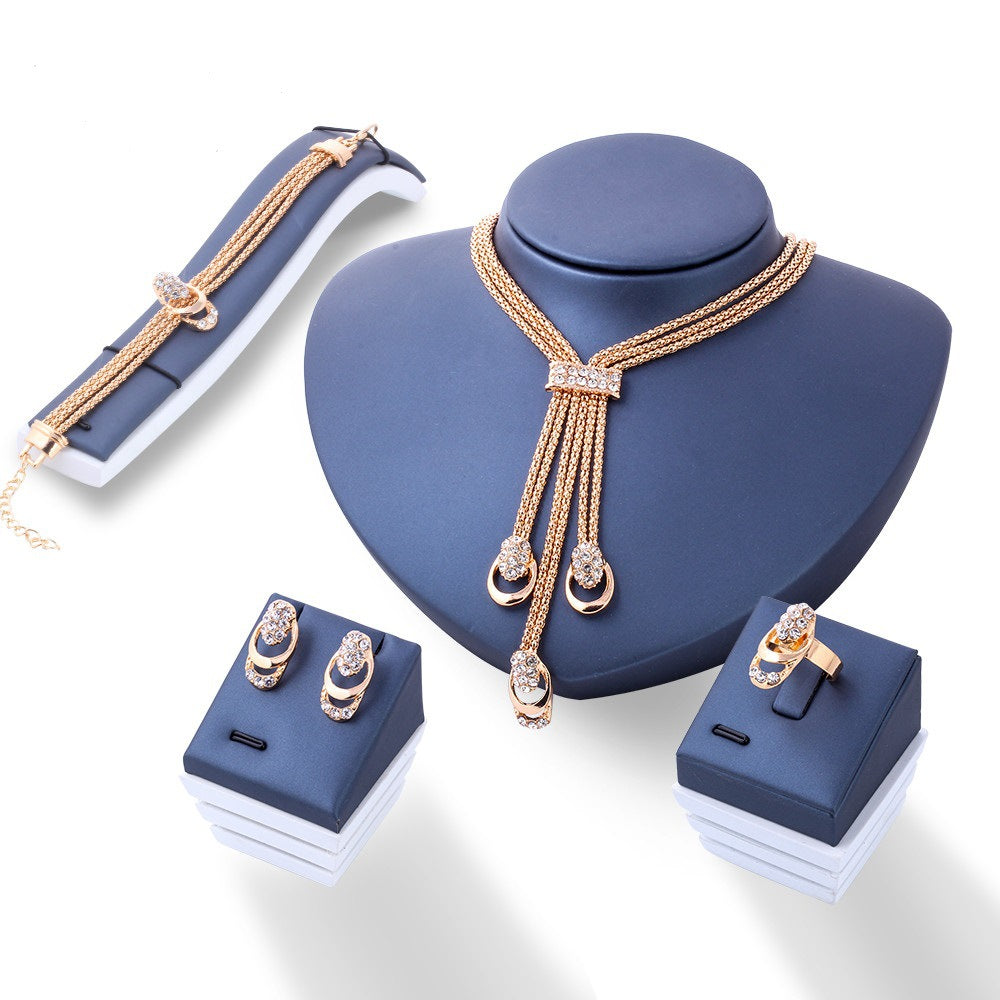 A luxurious 4 Piece Royal Jewelry Set featuring 18K gold plating and sparkling ® crystals, elegantly displayed.