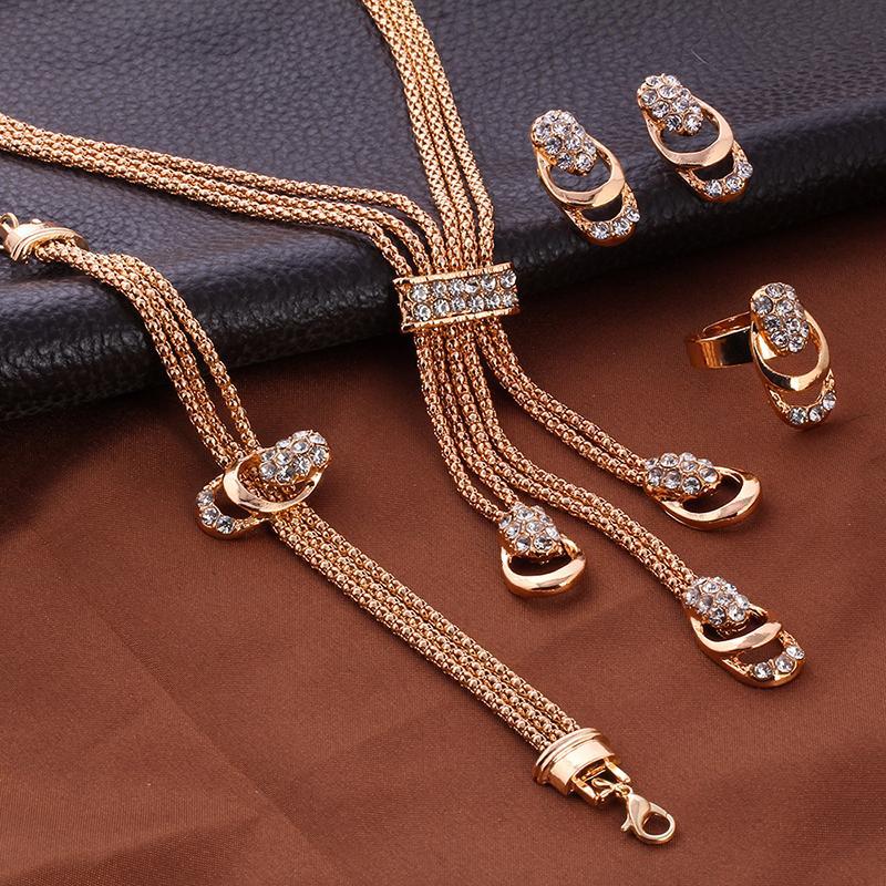 A luxurious 4 Piece Royal Jewelry Set featuring 18K gold plating and sparkling ® crystals, elegantly displayed.