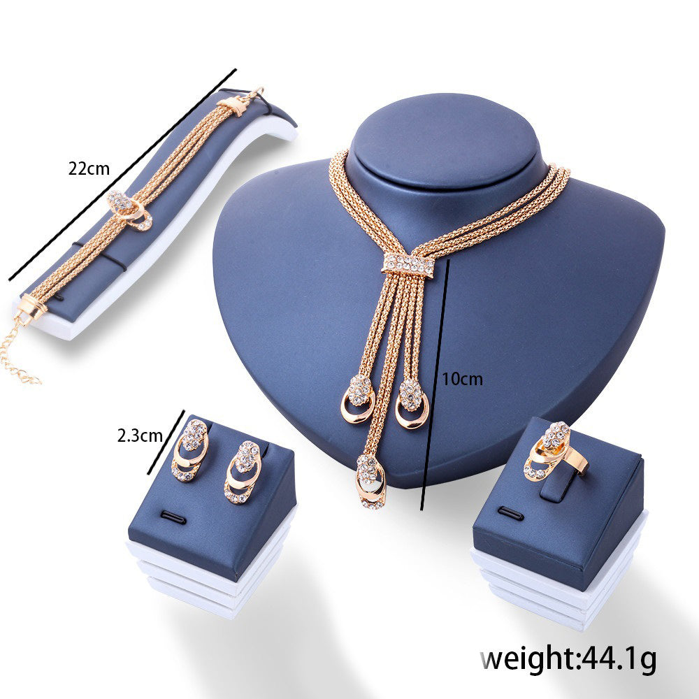 A luxurious 4 Piece Royal Jewelry Set featuring 18K gold plating and sparkling ® crystals, elegantly displayed.