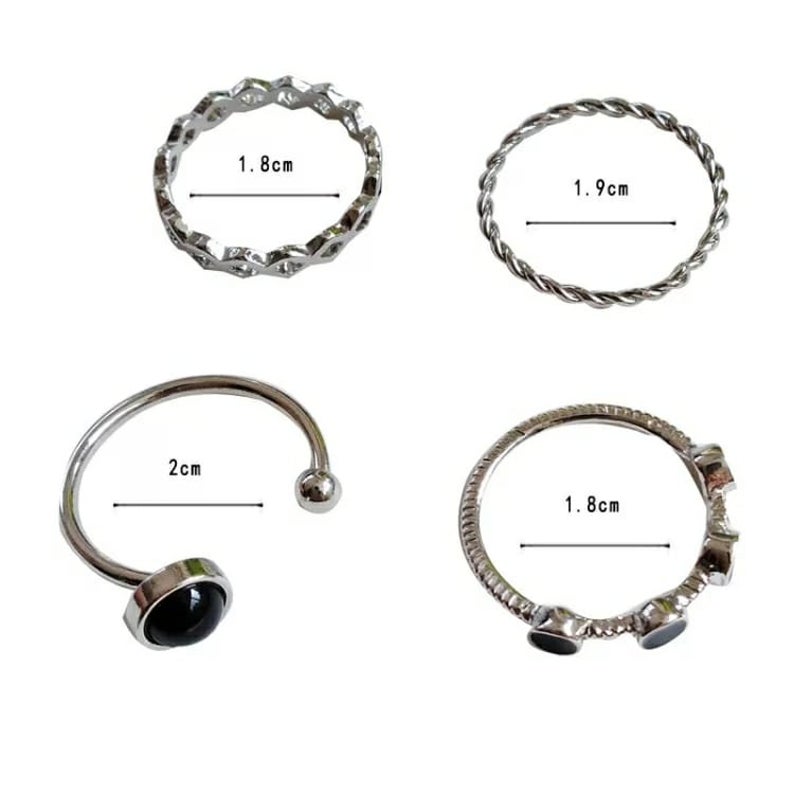 A stylish 4 piece silver and black stone stacking dainty open knuckle ring set, showcasing elegant designs with black gemstones.