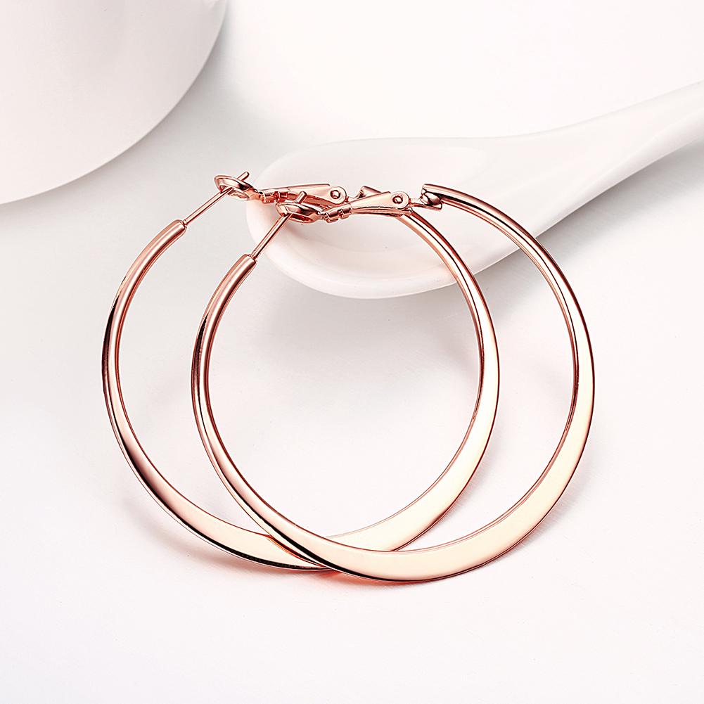 A pair of elegant 42mm flat hoop earrings in 18K rose gold plating, showcasing their shiny finish and comfortable design.