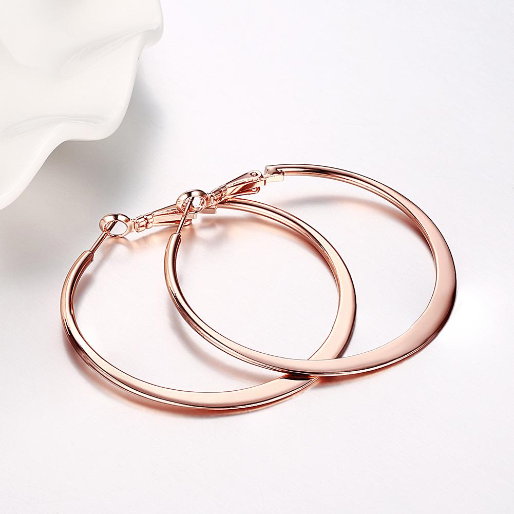 A pair of elegant 42mm flat hoop earrings in 18K rose gold plating, showcasing their shiny finish and comfortable design.