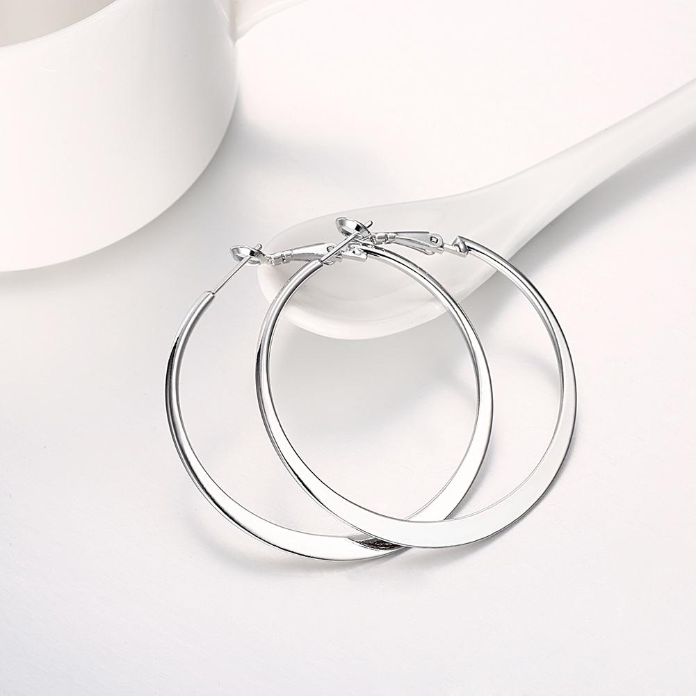 Elegant 42mm flat hoop earrings in 18K white gold plating, showcasing a shiny and sophisticated design suitable for any occasion.