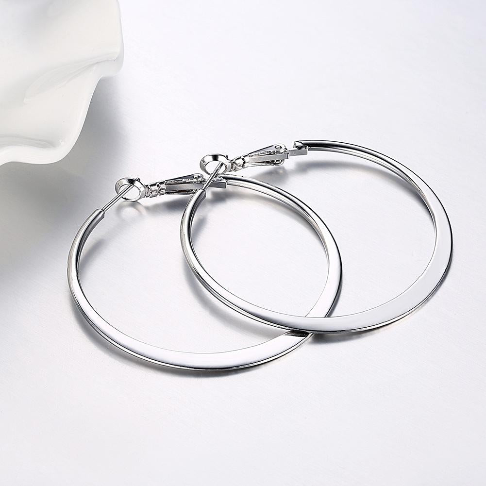 Elegant 42mm flat hoop earrings in 18K white gold plating, showcasing a shiny and sophisticated design suitable for any occasion.