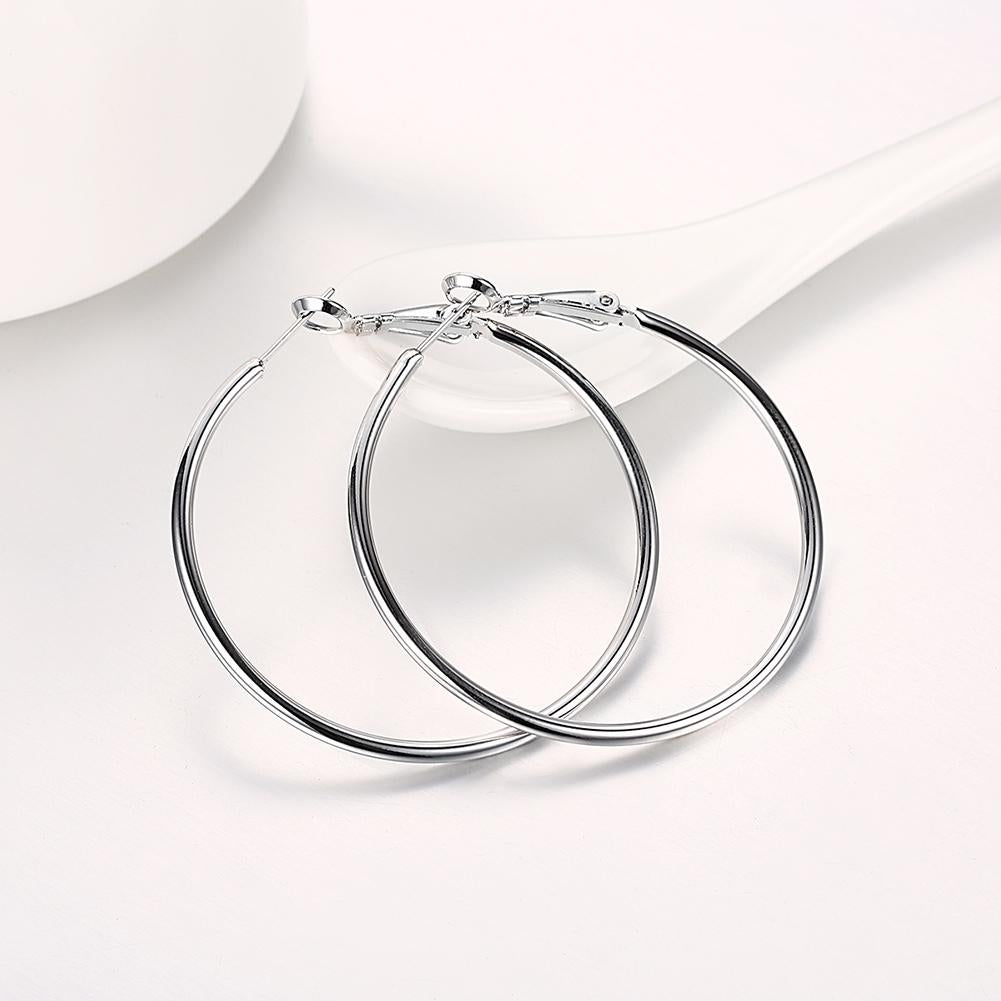 A pair of elegant 42mm round hoop earrings crafted in 18K white gold plating, showcasing a shiny and sophisticated design.