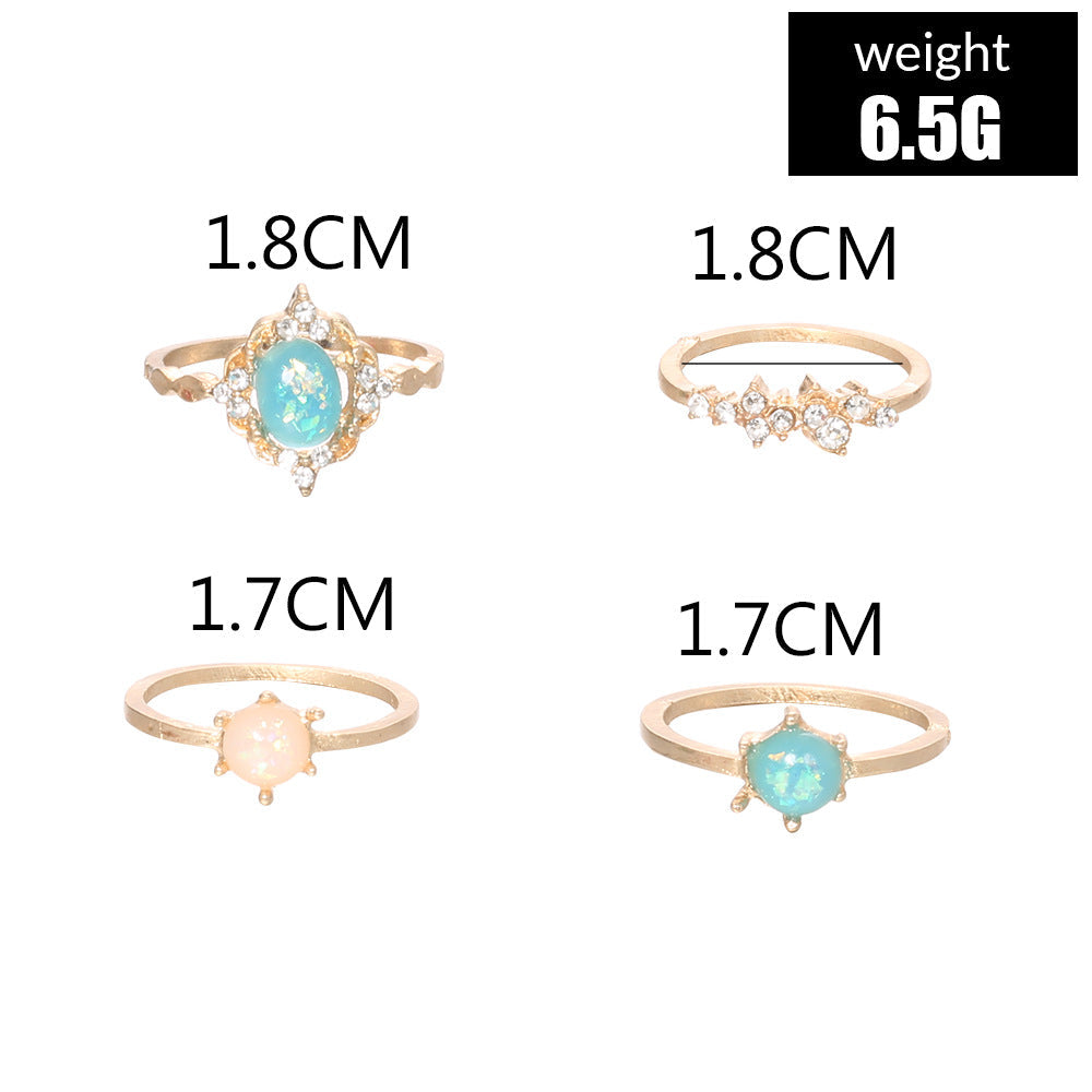 A beautiful 4-piece ring set featuring opal and white crystals, crafted from 14K gold-plated brass with a micro-pavé setting.