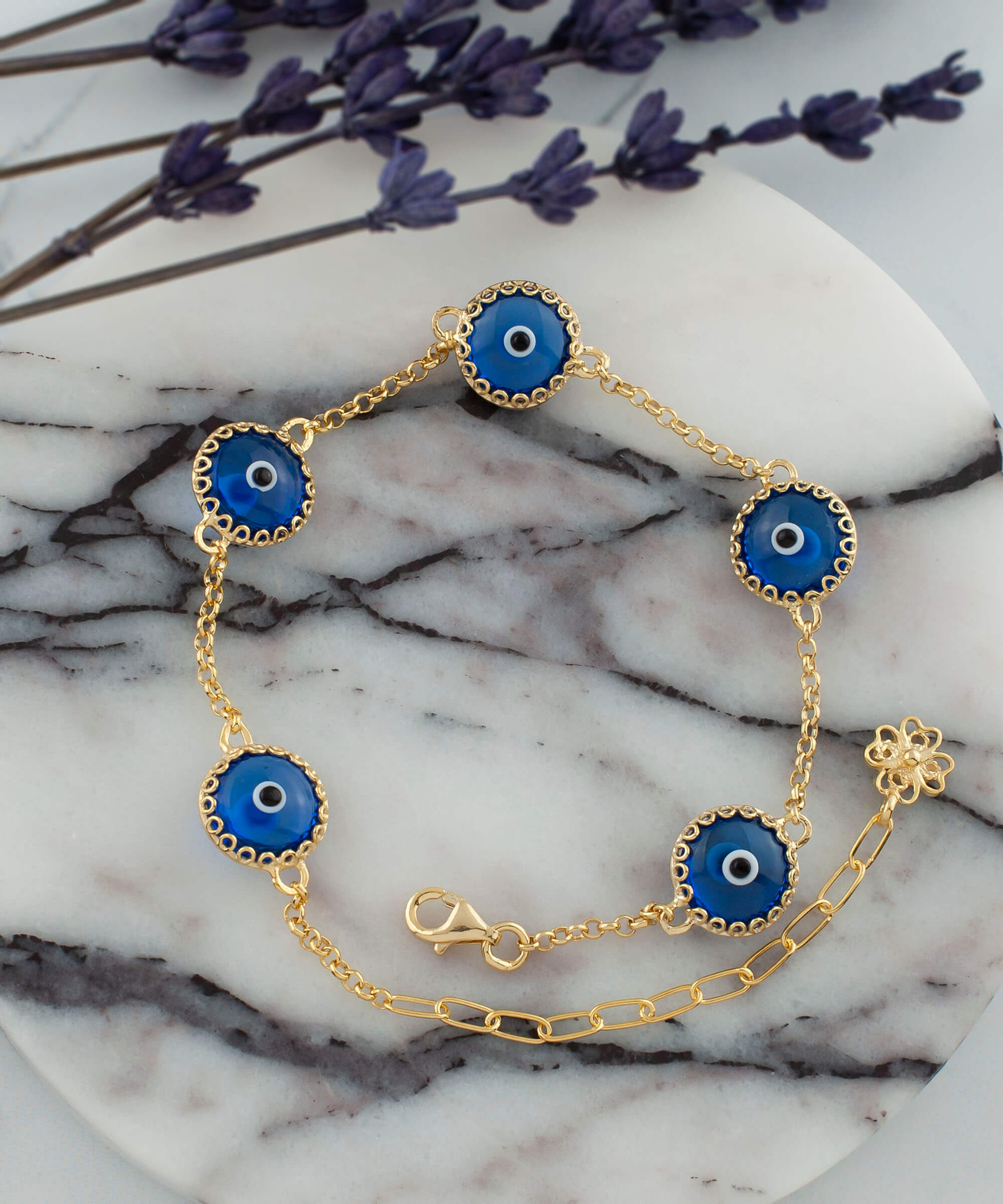 Gold plated sterling silver link bracelet featuring five blue evil eye beads, designed for women, with a lobster claw clasp.