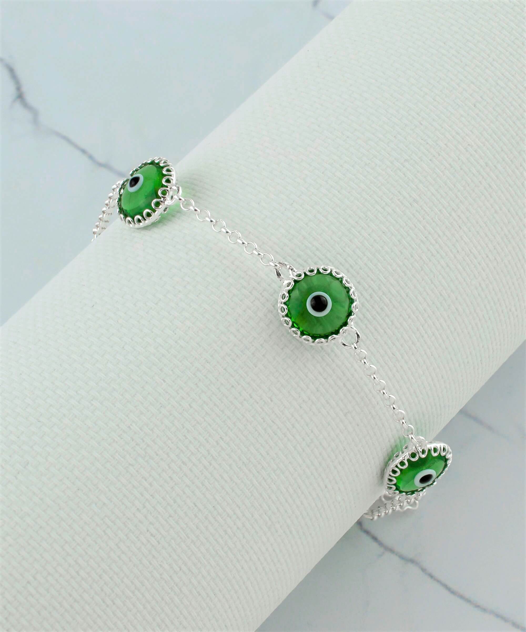 Mint green evil eye women silver link bracelet featuring five beads and a strong rolo chain, elegantly designed for protection and style.