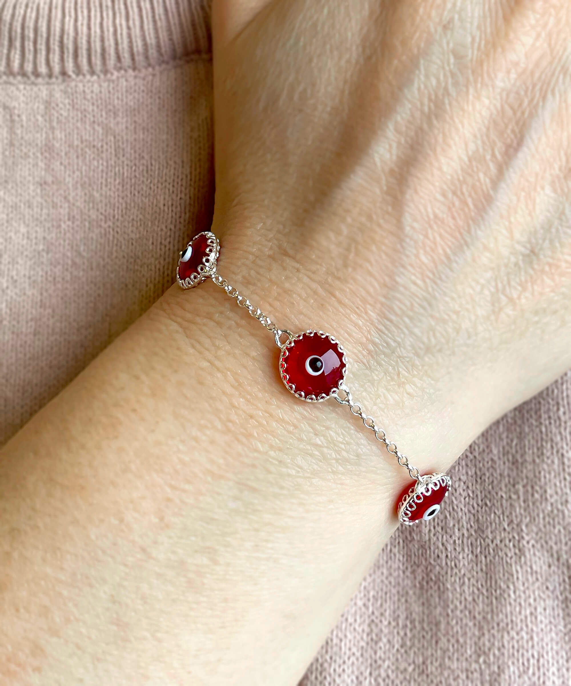 A stylish 5 Beads Red Evil Eye Women Silver Link Bracelet featuring five red evil eye beads wrapped in silver prongs on a rolo chain.