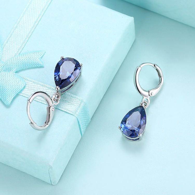 Elegant 5.55 CTTW sapphire pear shaped drop earrings set in 18K white gold, showcasing their stunning design and craftsmanship.