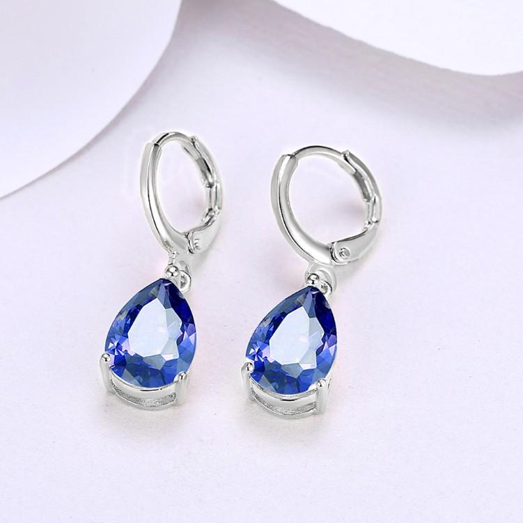 Elegant 5.55 CTTW sapphire pear shaped drop earrings set in 18K white gold, showcasing their stunning design and craftsmanship.