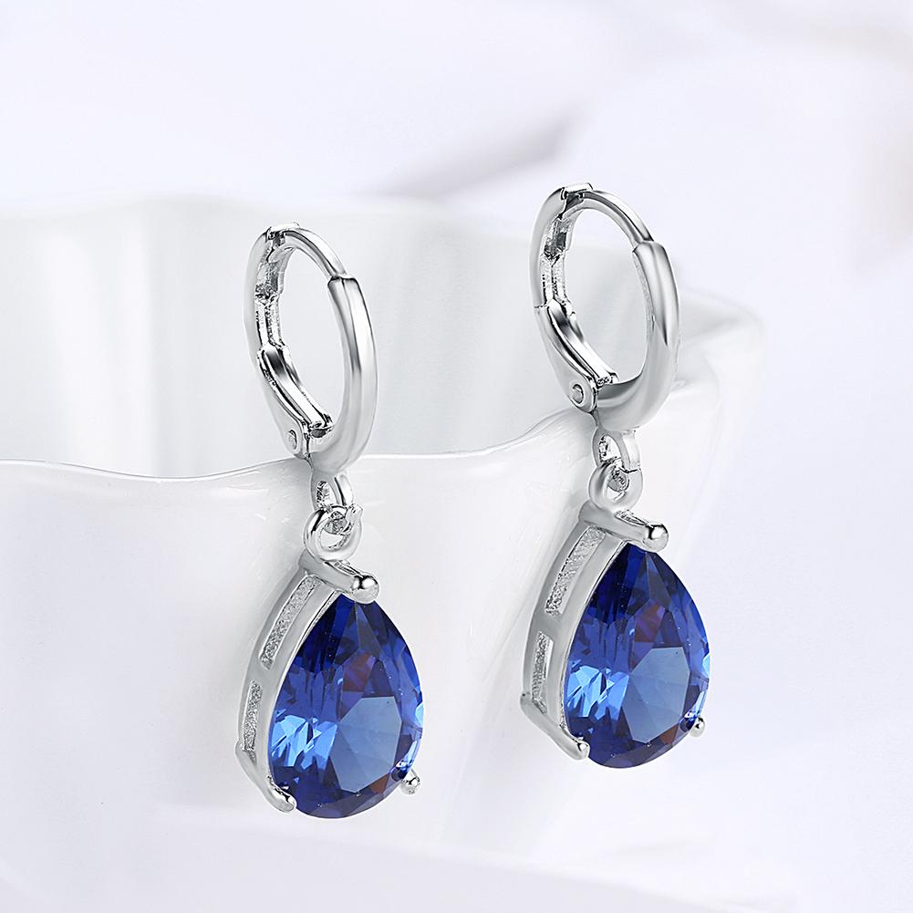 Elegant 5.55 CTTW sapphire pear shaped drop earrings set in 18K white gold, showcasing their stunning design and craftsmanship.