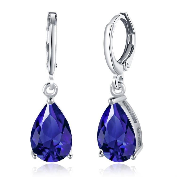 Elegant 5.55 CTTW sapphire pear shaped drop earrings set in 18K white gold, showcasing their stunning design and craftsmanship.