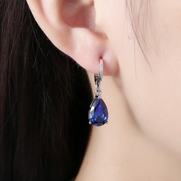 Elegant 5.55 CTTW sapphire pear shaped drop earrings set in 18K white gold, showcasing their stunning design and craftsmanship.