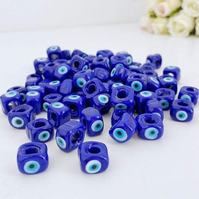 Five blue glass evil eye cube beads, each 10mm, showcasing a protective charm for DIY jewelry making.