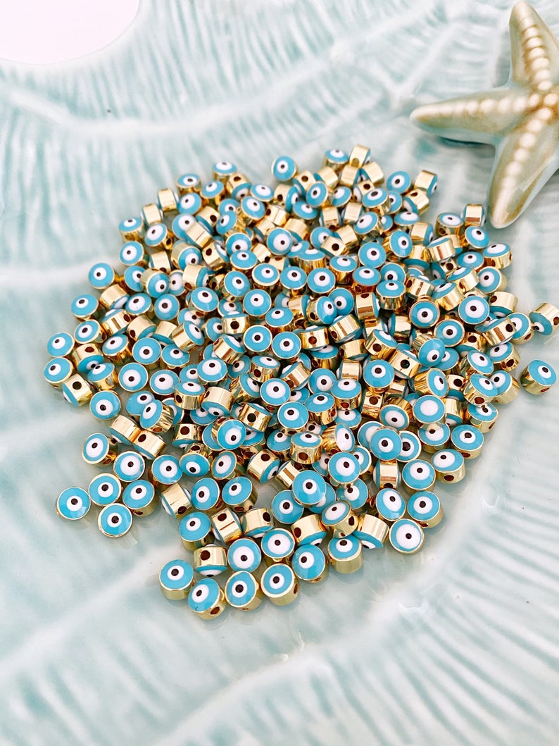 Five blue evil eye spacer beads with a 7mm size, featuring enamel connectors, ideal for DIY jewelry making.