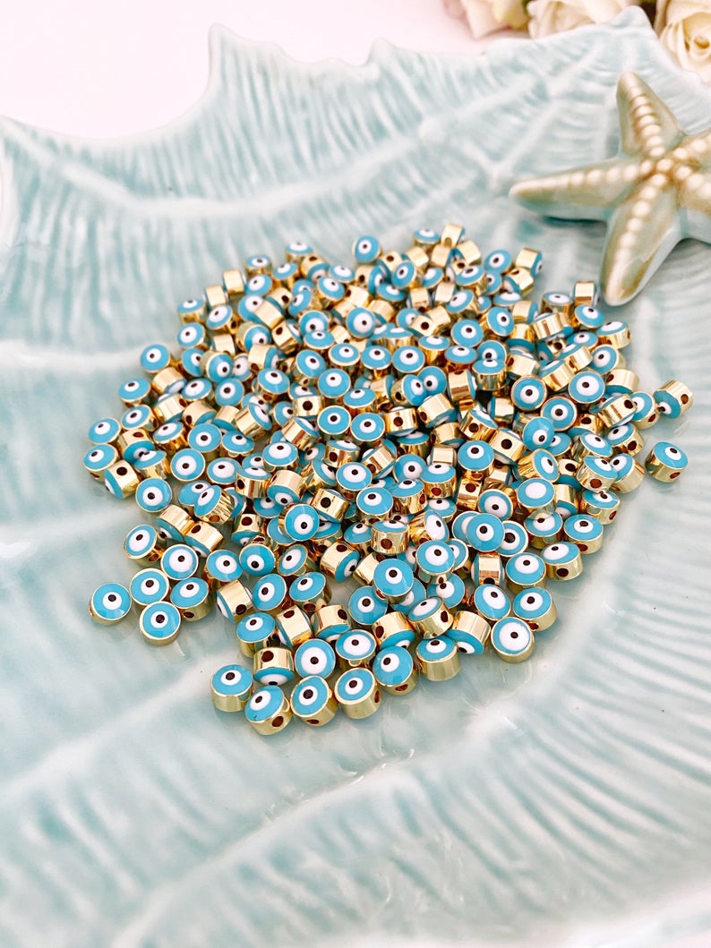 Five blue evil eye spacer beads with a 7mm size, featuring enamel connectors, ideal for DIY jewelry making.