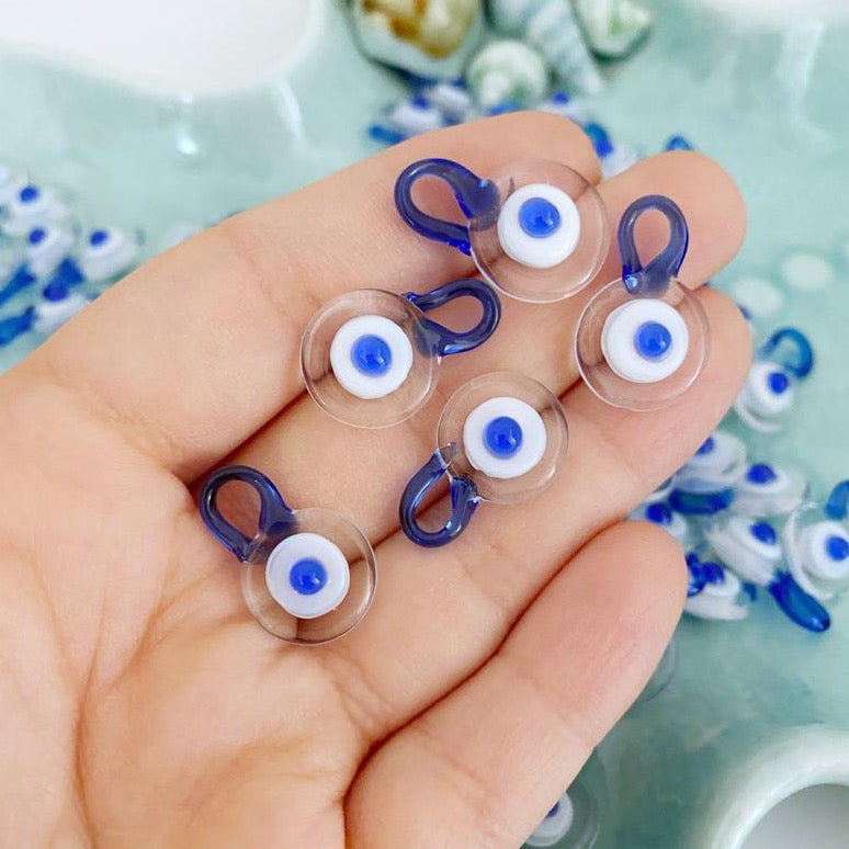 Five clear Murano glass evil eye beads, each 15mm in size, featuring a protective charm design.